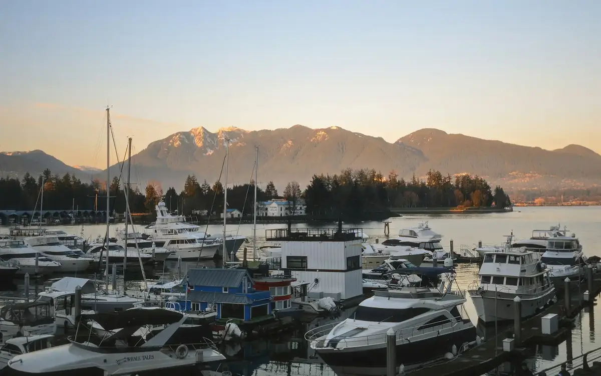 Coal Harbour marina at sunset, boats moored below the North Shore Mountains