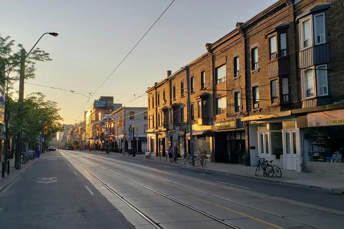 Early morning sun on the brick storefronts of College Street in Little Italy, Toronto