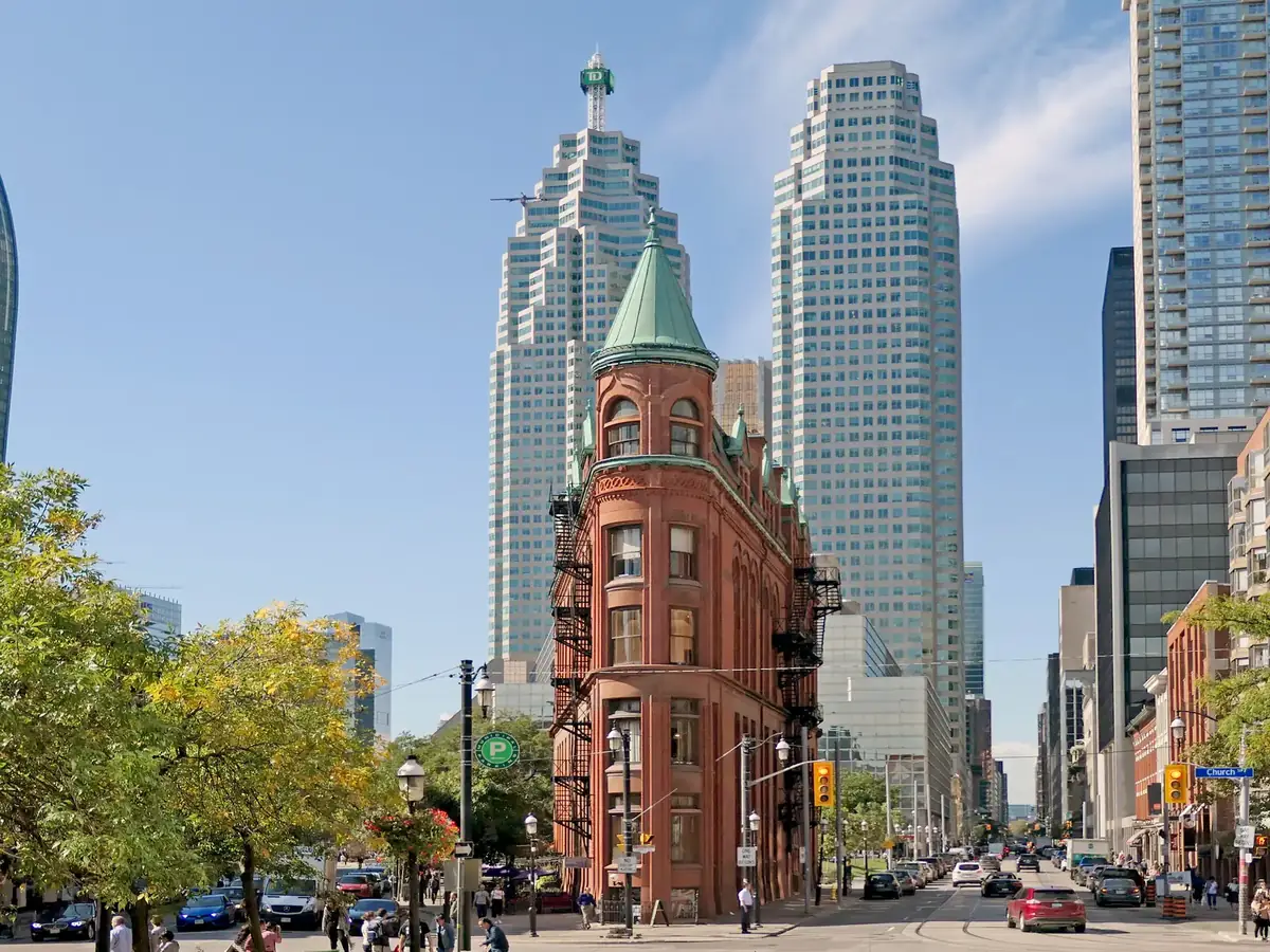 The red-brick Gooderham Flatiron Building under a blue sky in the St. Lawrence neighbourhood, Toronto