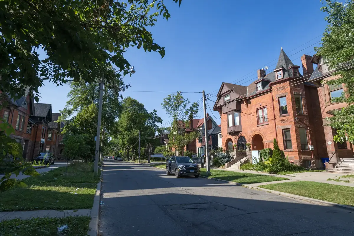 Victorian red-brick houses under summer trees on Madison Avenue in The Annex, Toronto