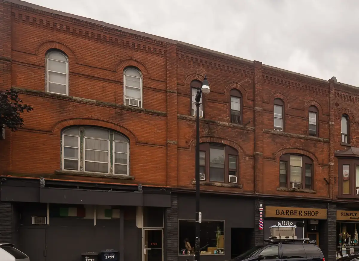 Victorian red-brick storefronts with arched windows on Dundas Street West in The Junction, Toronto