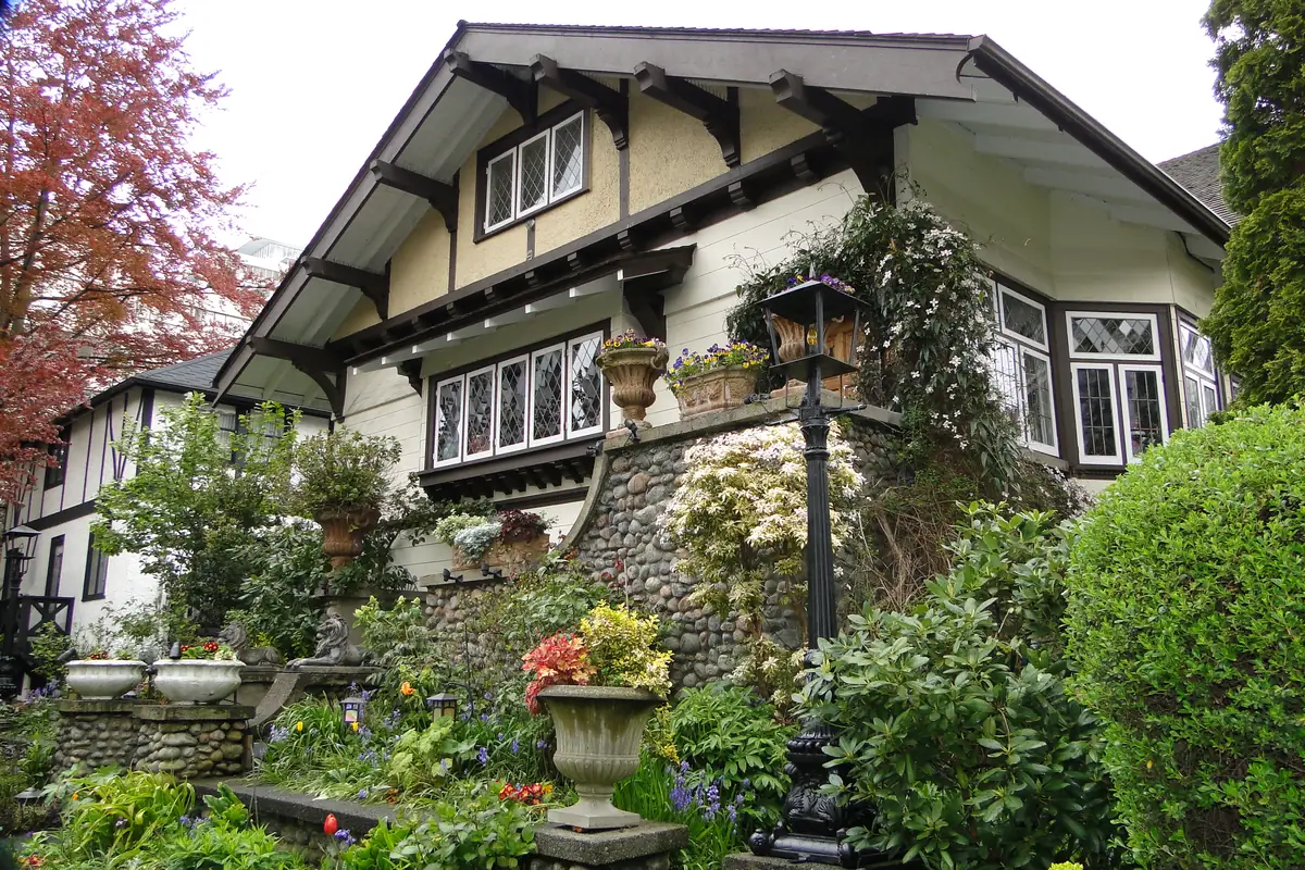 Craftsman-style character house with leaded windows above a spring garden in Kitsilano, Vancouver