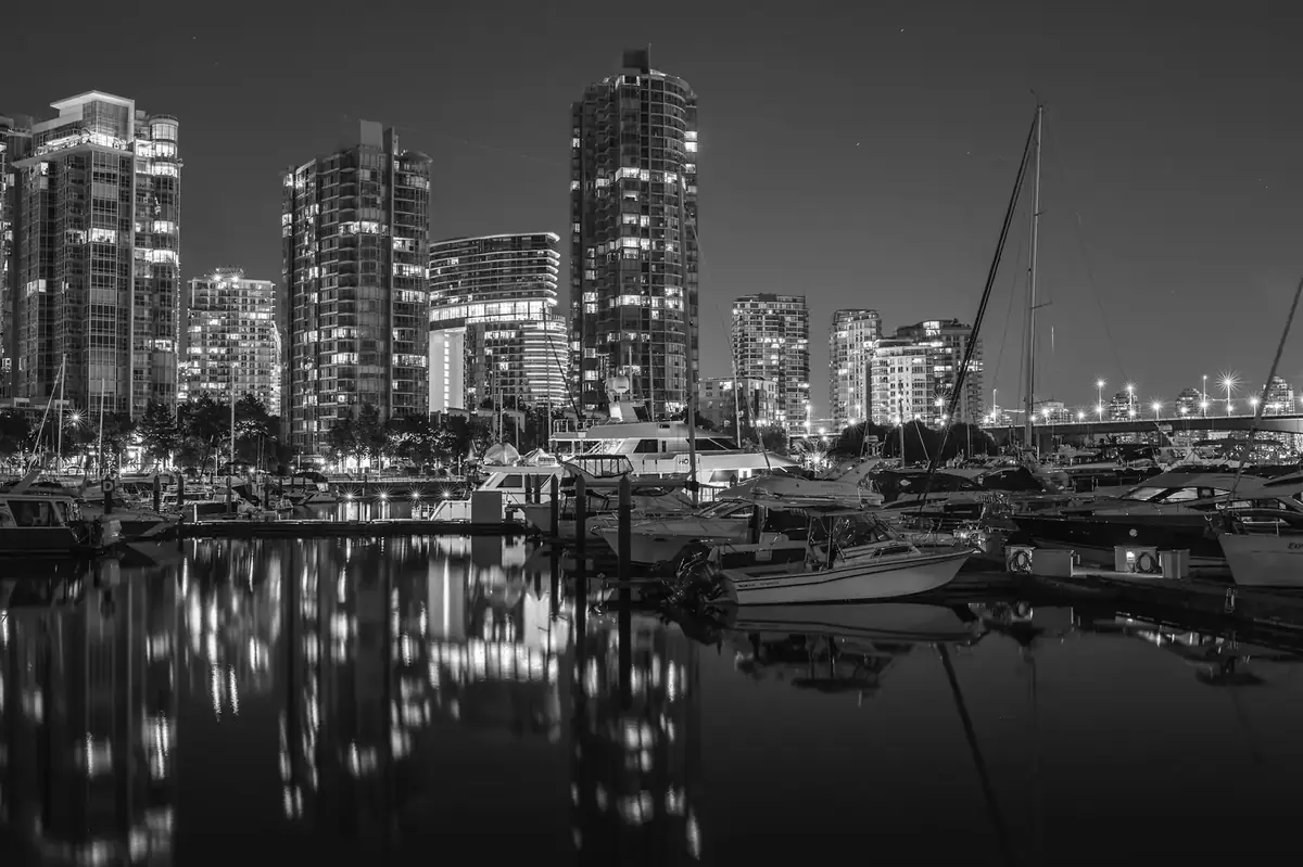 Yaletown’s seawall and glass condo towers reflected in the False Creek marina at night, Vancouver