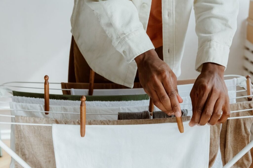 Hands Clipping Fresh Laundry on Dryer -