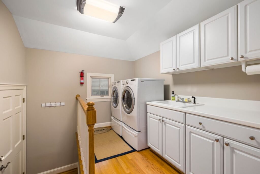 Tidy laundry room with washing machines and a utility sink