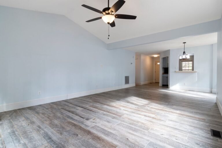 Bright airy living room with light blue walls and wooden floor