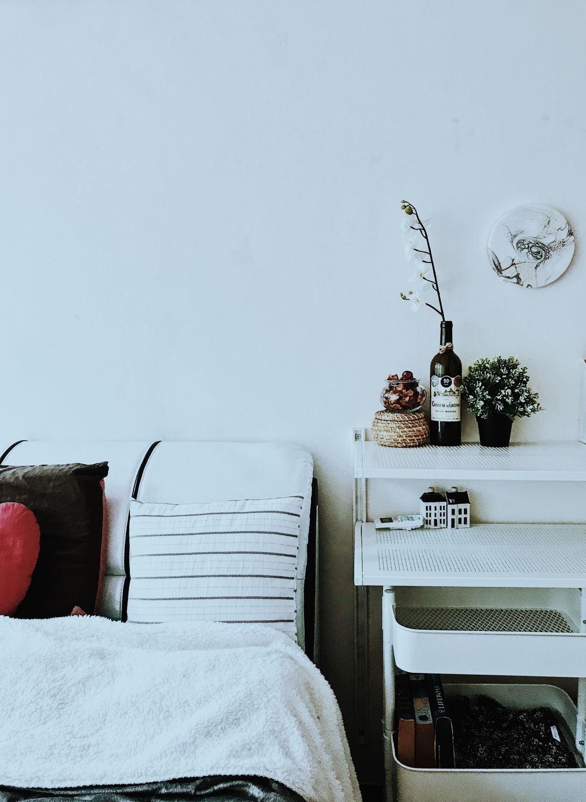 Tidy minimalist room with a white utility cart and potted plants